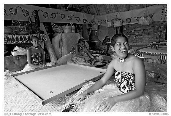 Fiji women sitting at a traditional pool table in vale ni bose (meeting) house. Polynesian Cultural Center, Oahu island, Hawaii, USA (black and white)