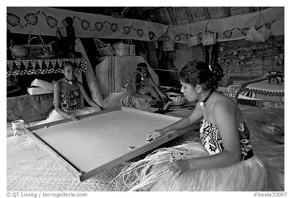 Fiji women playing at a traditional pool table in vale ni bose house. Polynesian Cultural Center, Oahu island, Hawaii, USA (black and white)