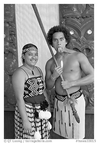 Maori woman and man sticking out his tongue. Polynesian Cultural Center, Oahu island, Hawaii, USA (black and white)