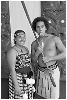Maori woman and man sticking out his tongue. Polynesian Cultural Center, Oahu island, Hawaii, USA ( black and white)