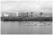 Outrigger canoe along the Ala Wai Canal. Waikiki, Honolulu, Oahu island, Hawaii, USA (black and white)