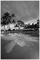 Swimming pool at sunset, Halekulani hotel. Waikiki, Honolulu, Oahu island, Hawaii, USA ( black and white)