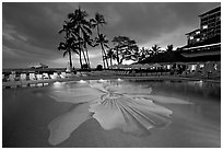 Swimming pool at sunset, Halekulani hotel. Waikiki, Honolulu, Oahu island, Hawaii, USA (black and white)