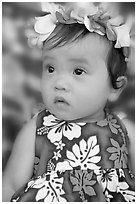 Baby girl in hawaiian dress wearing a flower lei on her head. Waikiki, Honolulu, Oahu island, Hawaii, USA (black and white)
