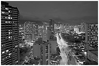 Boulevard and high-rise towers at dusk. Waikiki, Honolulu, Oahu island, Hawaii, USA ( black and white)