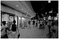 Shops on Kalakaua avenue at night. Waikiki, Honolulu, Oahu island, Hawaii, USA ( black and white)