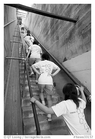 Women climbing a staircase on the Diamond Head summit trail. Oahu island, Hawaii, USA (black and white)