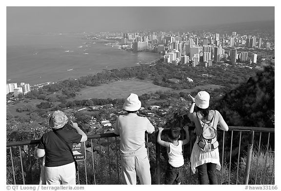 Tourists look at Waikidi from the  Diamond Head crater, early morning. Oahu island, Hawaii, USA (black and white)