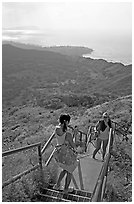 Tourists take a photo on the last steps of the Diamond Head crater summit trail. Oahu island, Hawaii, USA ( black and white)