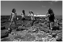 Girls playing in tidepool, Kukuila. Kauai island, Hawaii, USA ( black and white)
