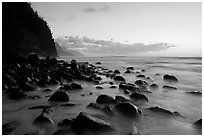 Boulders, surf, and Na Pali Coast, Kee Beach, dusk. Kauai island, Hawaii, USA ( black and white)
