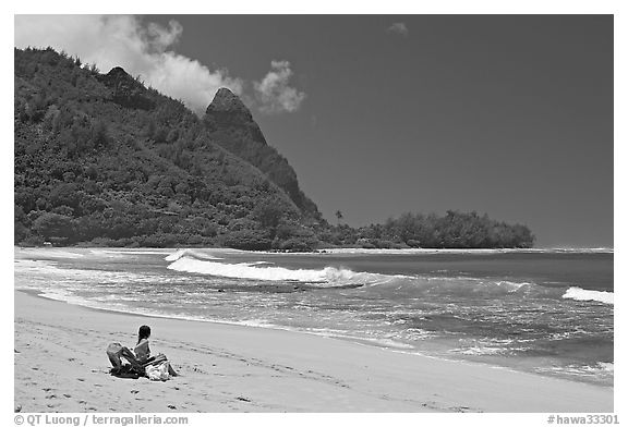 Woman sitting on a beach chair on Makua (Tunnels) Beach. North shore, Kauai island, Hawaii, USA (black and white)