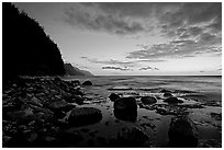 Boulders, surf, and Na Pali Coast, dusk. Kauai island, Hawaii, USA (black and white)