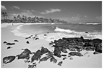 Dark rocks and Kiahuna Beach, mid-day. Kauai island, Hawaii, USA ( black and white)