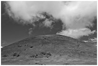 Cinder cone covered with grass, clouds. Big Island, Hawaii, USA (black and white)