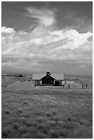 Rural building with bright red roof in ranchland. Big Island, Hawaii, USA (black and white)