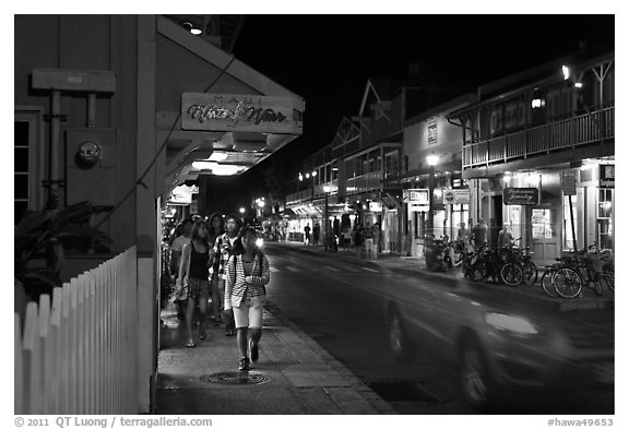 Tourists strolling store-lined street at night. Lahaina, Maui, Hawaii, USA (black and white)