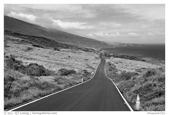 Road across arid landscape. Maui, Hawaii, USA