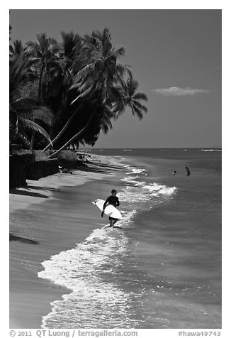 Surfer walking on beach. Lahaina, Maui, Hawaii, USA
