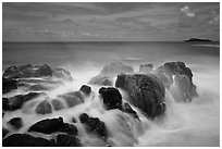 Rock with water motion and Mokuaeae island. Kauai island, Hawaii, USA (black and white)