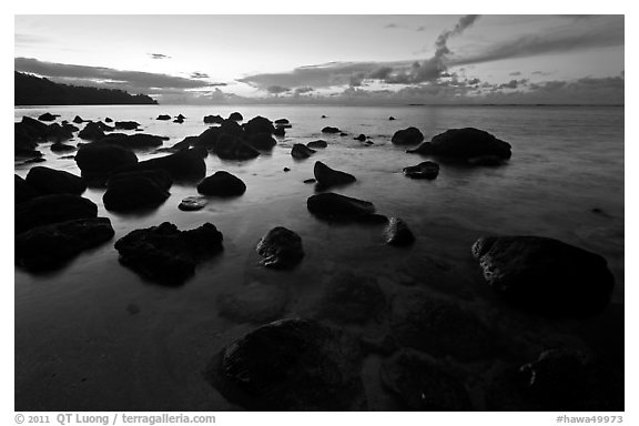 Boulders in water near Kalihika Park, sunset. Kauai island, Hawaii, USA