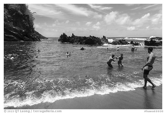 Beach-goers at Red Sand Beach, Hana. Maui, Hawaii, USA (black and white)