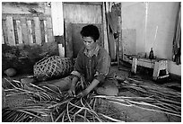 Woman weaving a toga (mat) out of pandamus leaves. American Samoa (black and white)