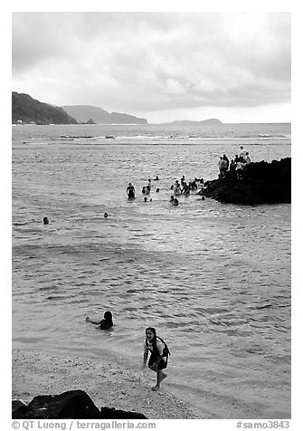 Children playing in water near Fugaalu. Pago Pago, Tutuila, American Samoa (black and white)