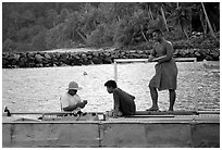 Men on a ferry to Aunuu. Aunuu Island, American Samoa (black and white)