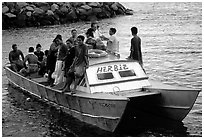 Villagers crowd a ferry to Aunuu. Aunuu Island, American Samoa ( black and white)