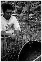 Villager weaving a basket out of a single palm leaf. Tutuila, American Samoa ( black and white)