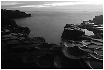 Ancient grinding stones (foaga) and Leone Bay at dusk. Tutuila, American Samoa ( black and white)