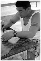 Young man drawing an artwork based on traditional siapo designs. Pago Pago, Tutuila, American Samoa ( black and white)
