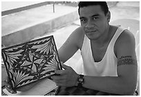 Young man showing an artwork based on traditional siapo designs. Pago Pago, Tutuila, American Samoa ( black and white)