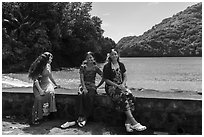 Samoan girls sitting on seawall, Fagasa. Tutuila, American Samoa ( black and white)