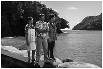 Samoan boys standing on seawall, Fagasa. Tutuila, American Samoa ( black and white)