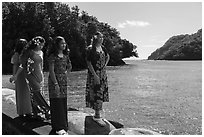 Samoan girls standing on seawall in Fagasa Bay. Tutuila, American Samoa ( black and white)