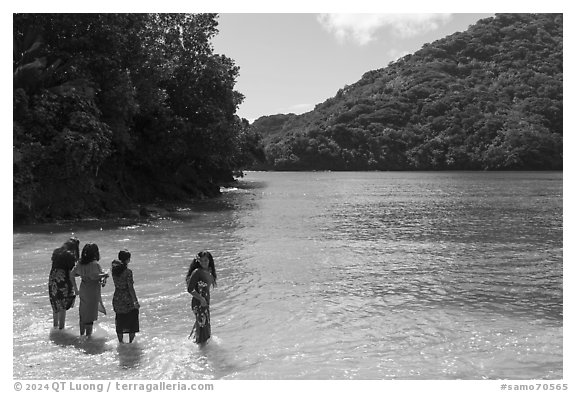 Samoan women standing in water in Fagasa Bay. Tutuila, American Samoa (black and white)