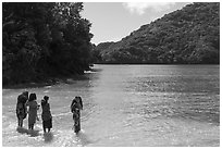 Samoan women standing in water in Fagasa Bay. Tutuila, American Samoa ( black and white)