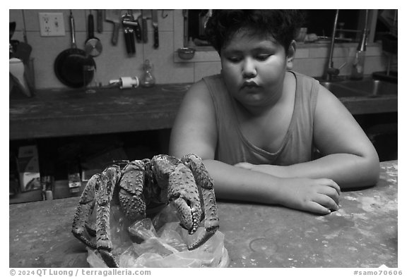 George looking at frozen coconut crab, Ofu Island. American Samoa (black and white)