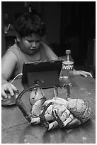 Frozen coconut crab and Samoan boy, Ofu Island. American Samoa ( black and white)