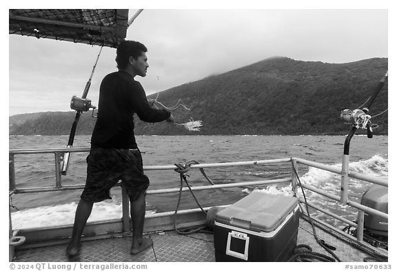 Samoan man fishing on alia boat. American Samoa (black and white)