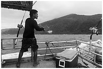 Samoan man fishing on alia boat. American Samoa ( black and white)