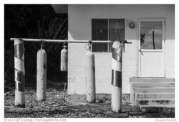 Scuba tanks used as curfew bells, Fagamalo. Tutuila, American Samoa (black and white)