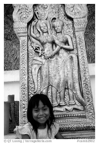 Girl and sculpture at Wat Phnom. Phnom Penh, Cambodia (black and white)