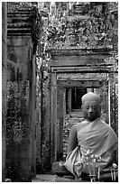 Buddha image, swathed in reverence, with offerings, the Bayon. Angkor, Cambodia ( black and white)