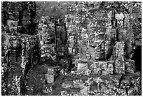 Large stone smiling faces on upper terrace, the Bayon. Angkor, Cambodia (black and white)