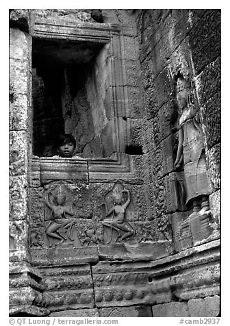 Boy hides in the Bayon. Angkor, Cambodia