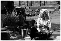 Incence vendor wearing traditional headcloth. Angkor, Cambodia (black and white)