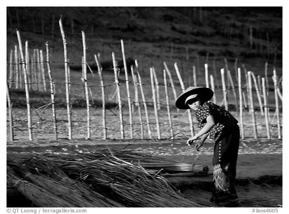 Villager and fence. Mekong river, Laos (black and white)